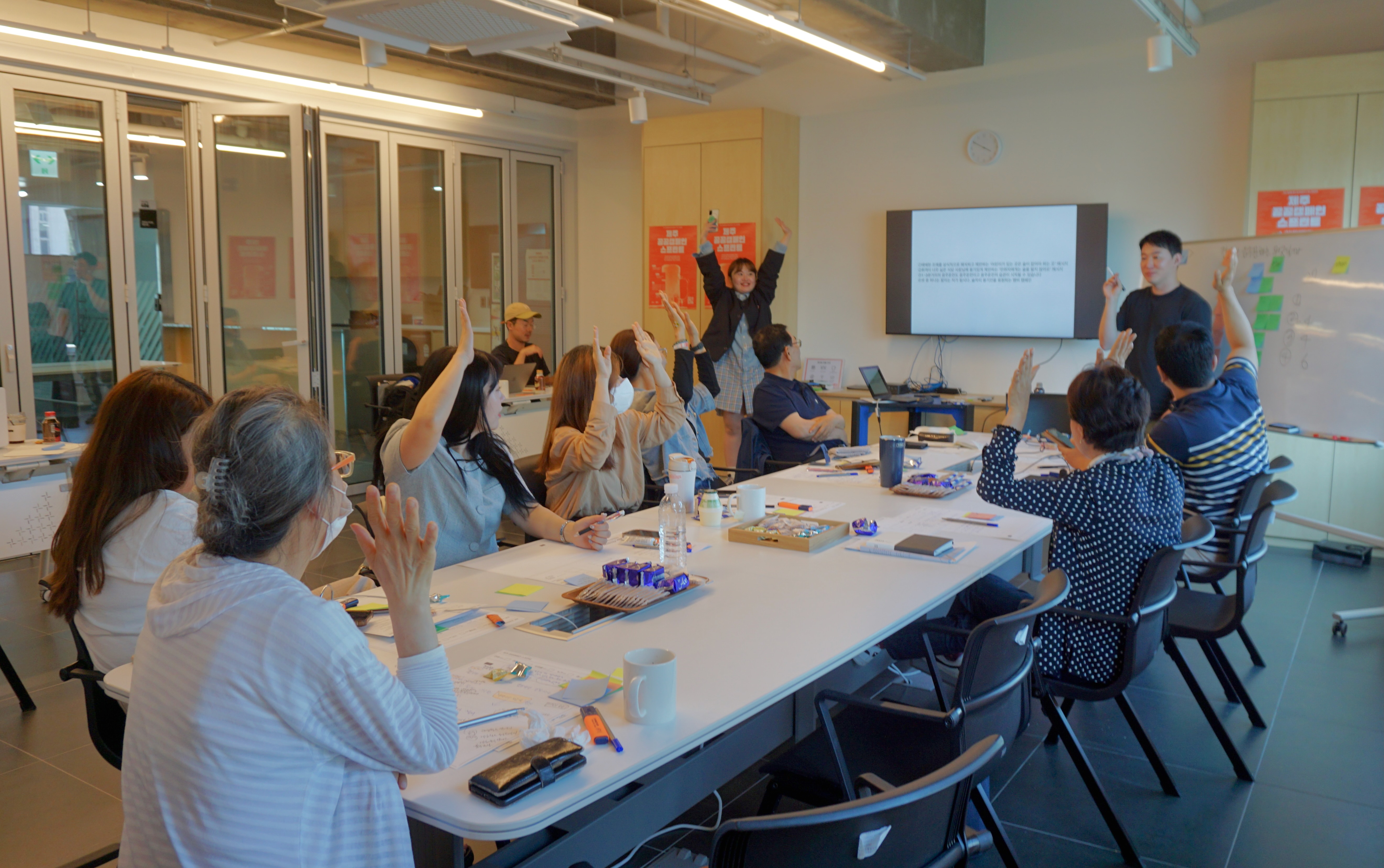 Participants taking part in a social issue sprint workshop in Jeju
